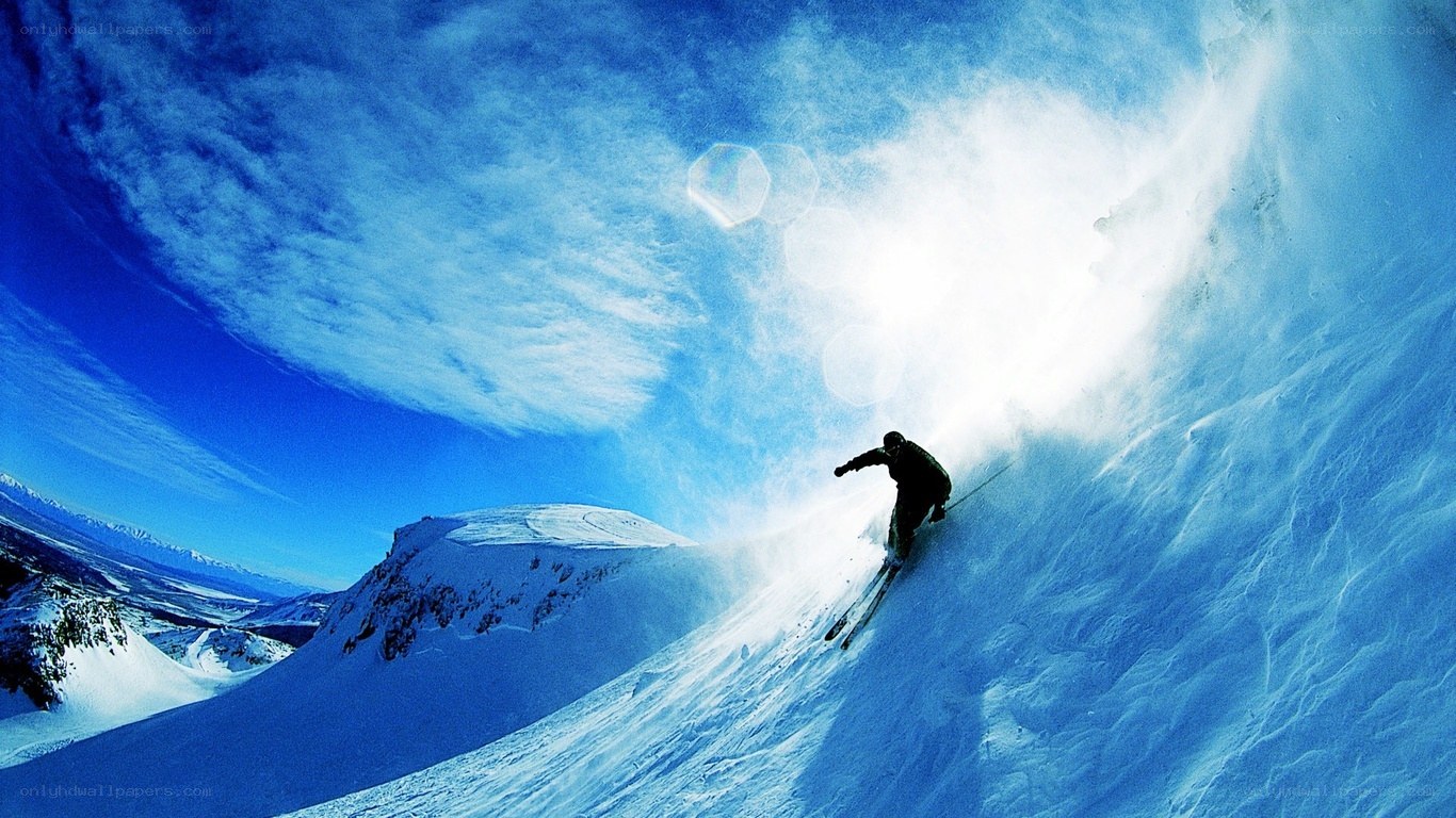 Skier carving down snowy slope