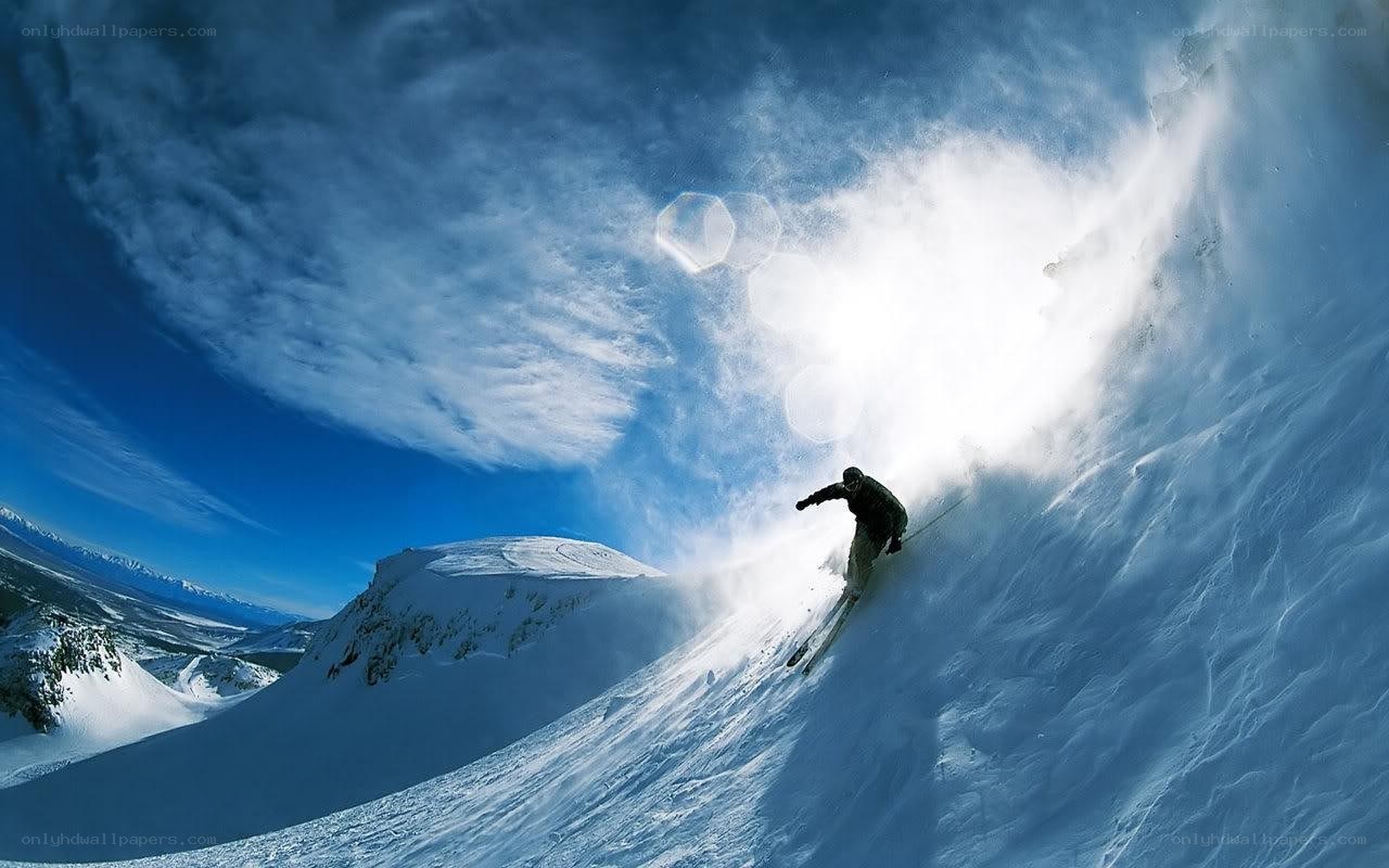 Skier carving down snowy slope