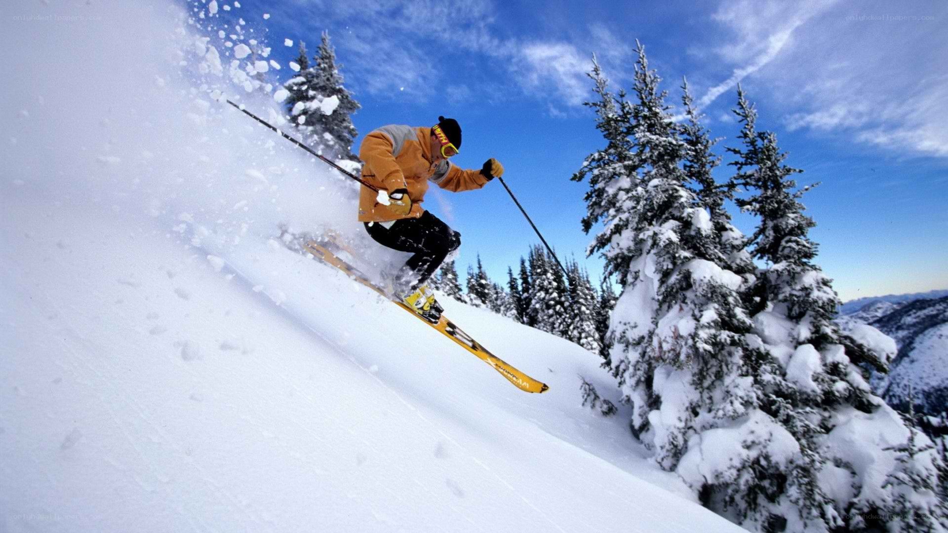 Skier carving down snowy slope