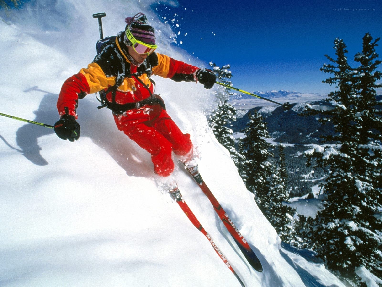 Skier carving down snowy slope