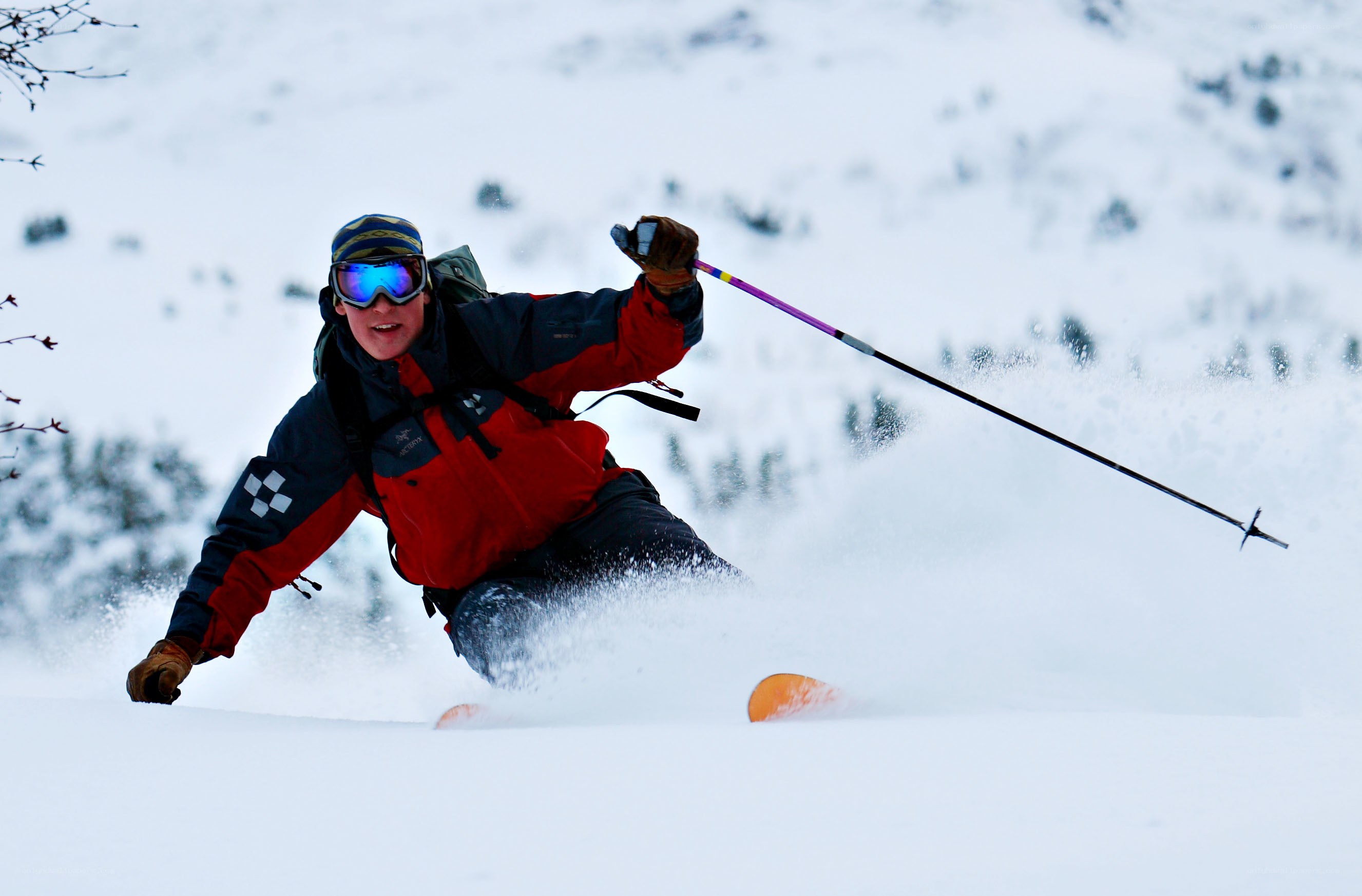 Skier carving through powder