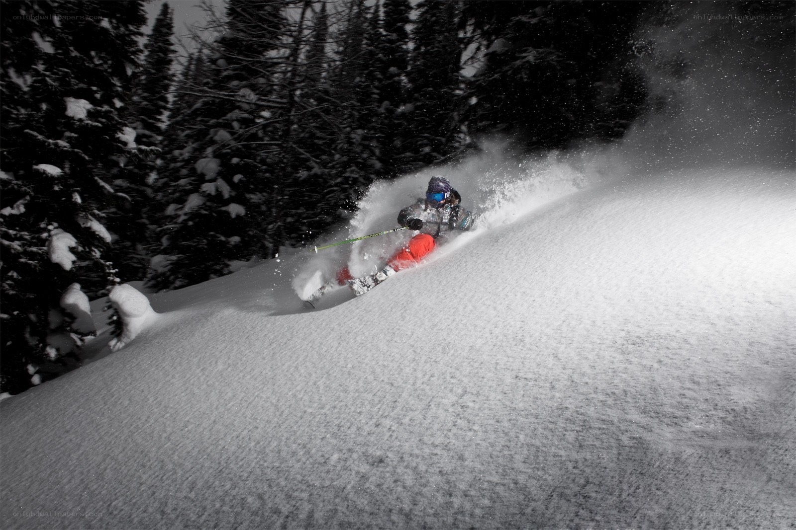 Skier carving through powder