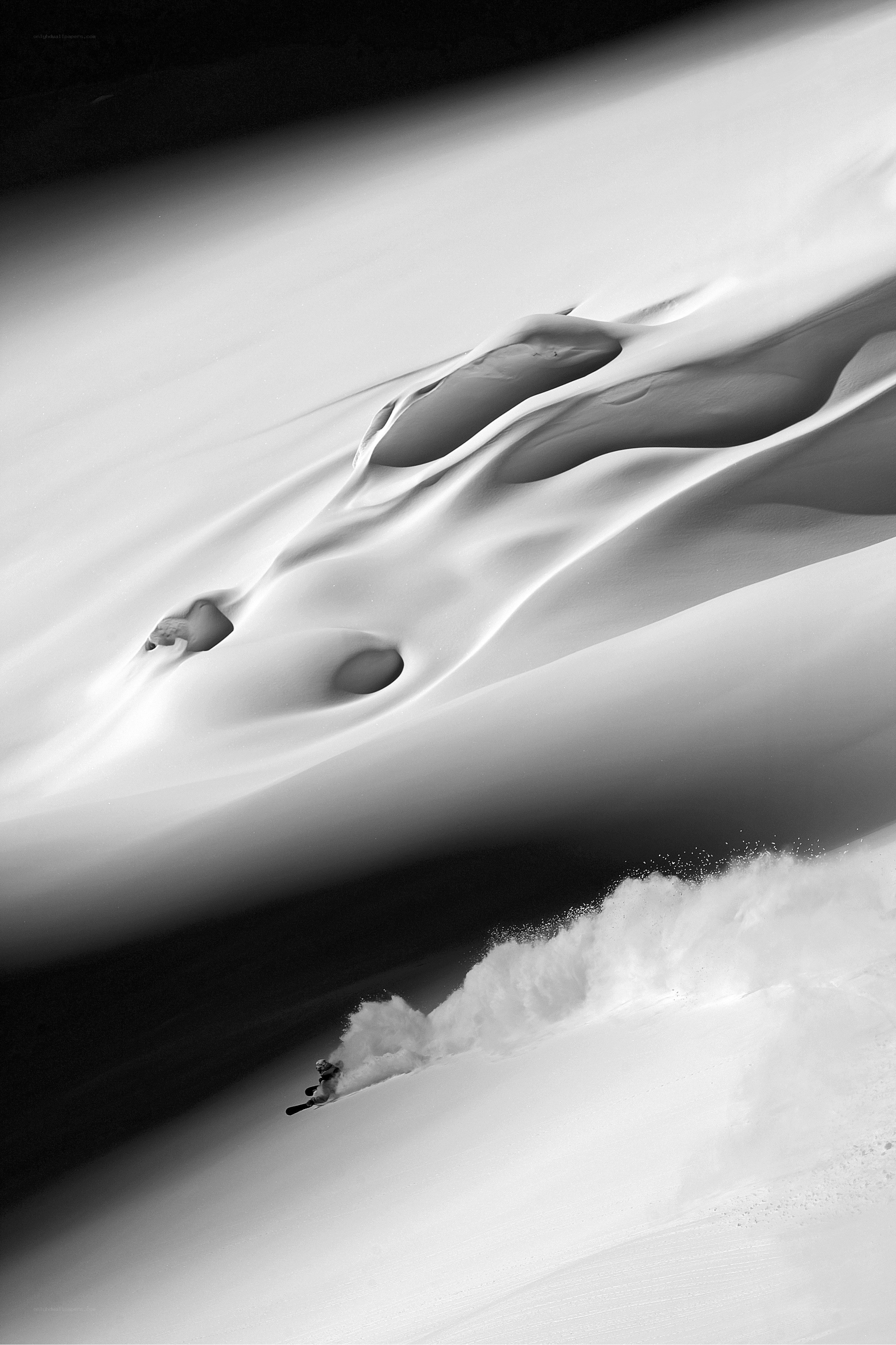 Skier carving through powder