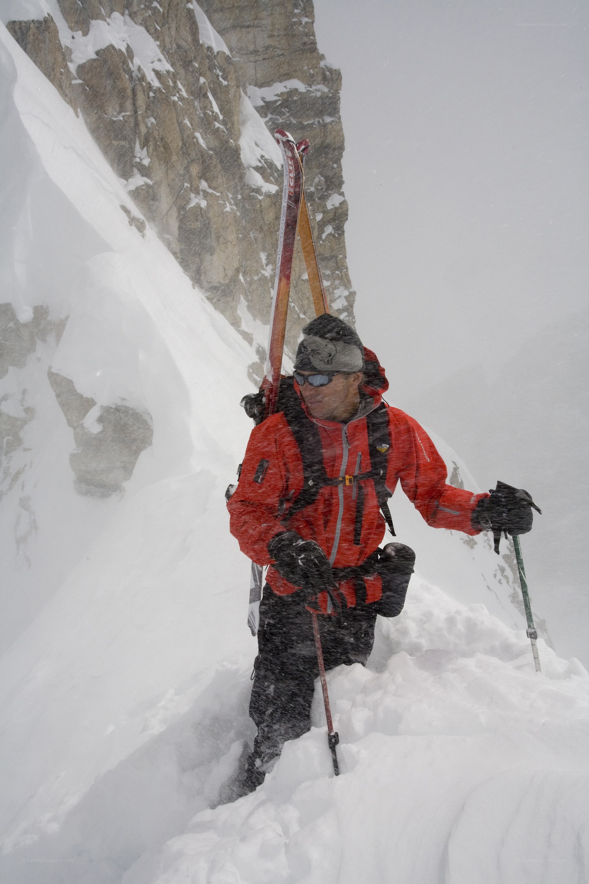 Skier climbing snowy mountain
