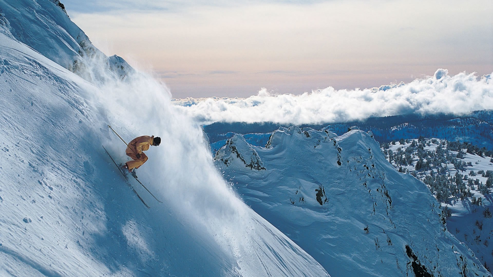 Skier descending snowy mountain