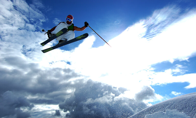 Skier in Mid-air Jump — Blue, Dramatic, Afternoon