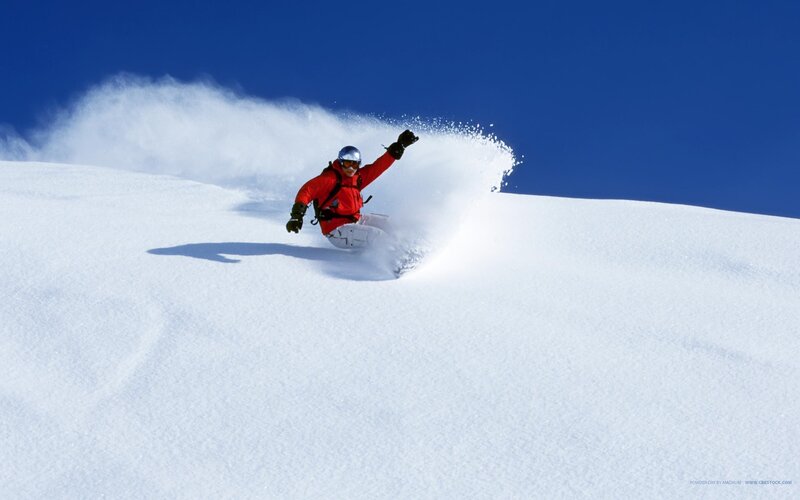 Skier in red on snowy slope