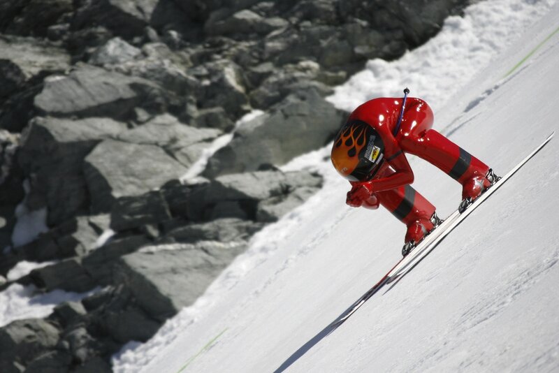 Skier in red suit on snowy slope
