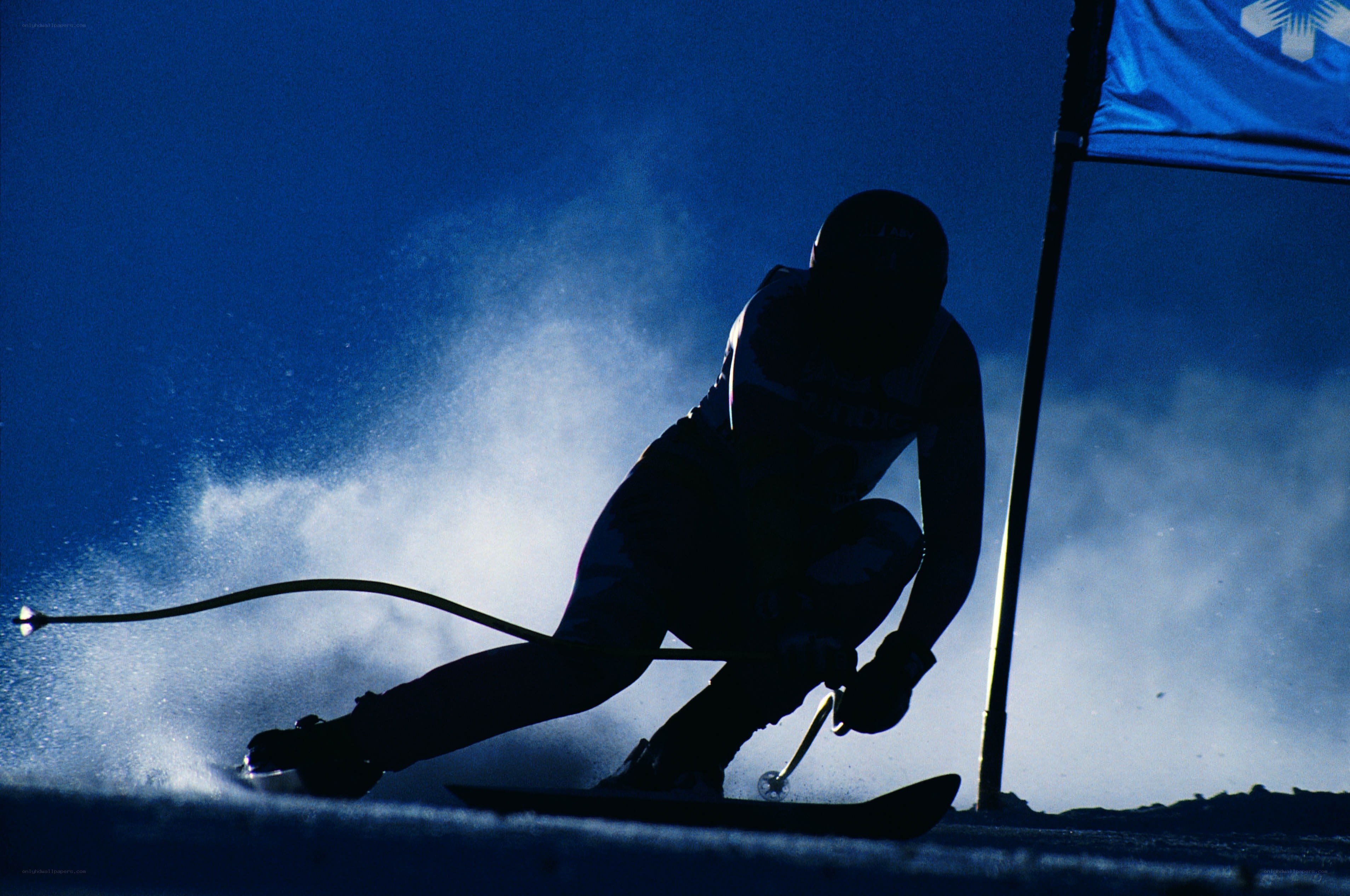 Skier in silhouette at night