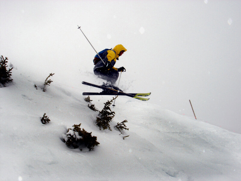 Skier jumping in snowy landscape