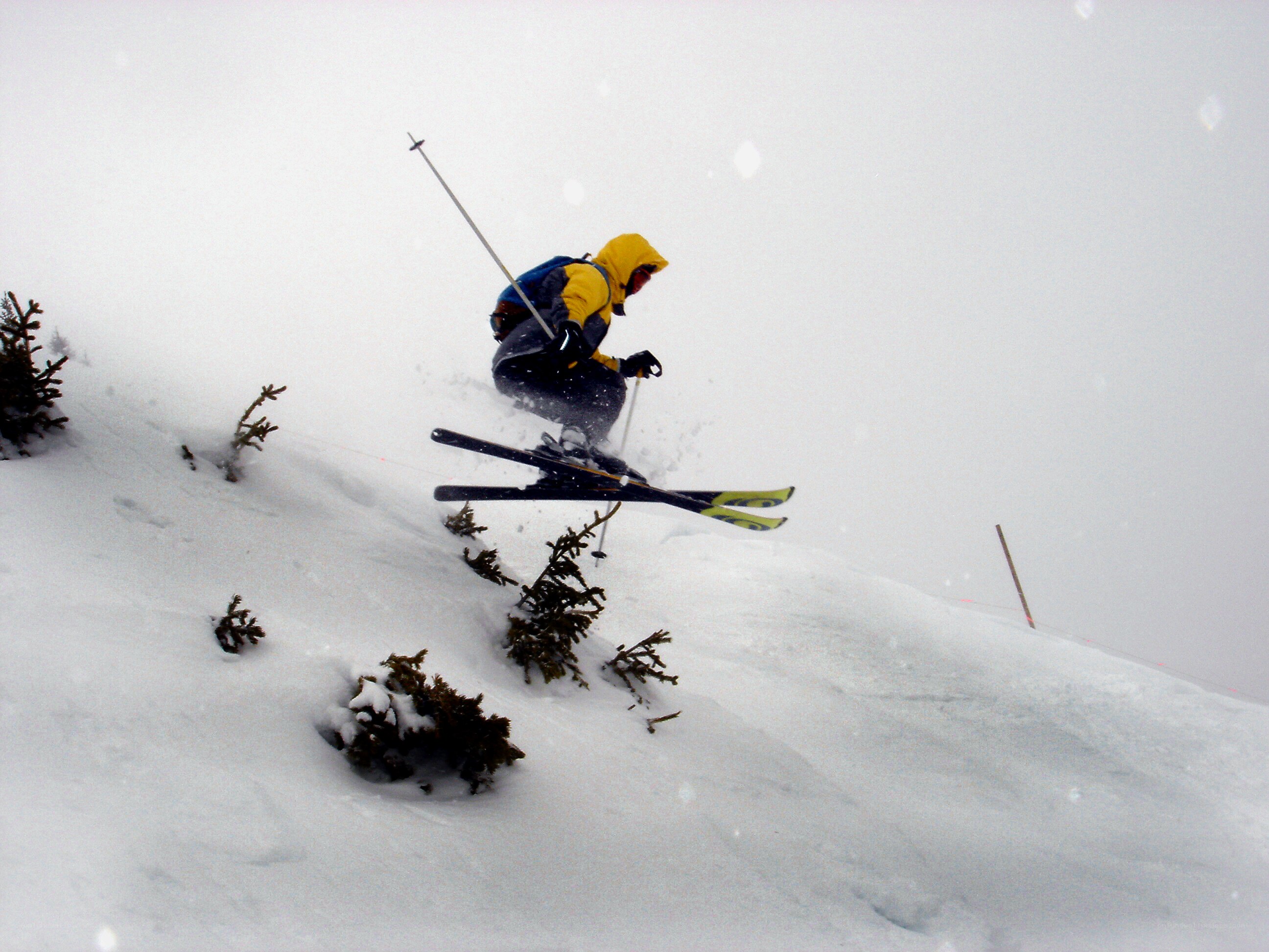 Skier jumping in snowy landscape