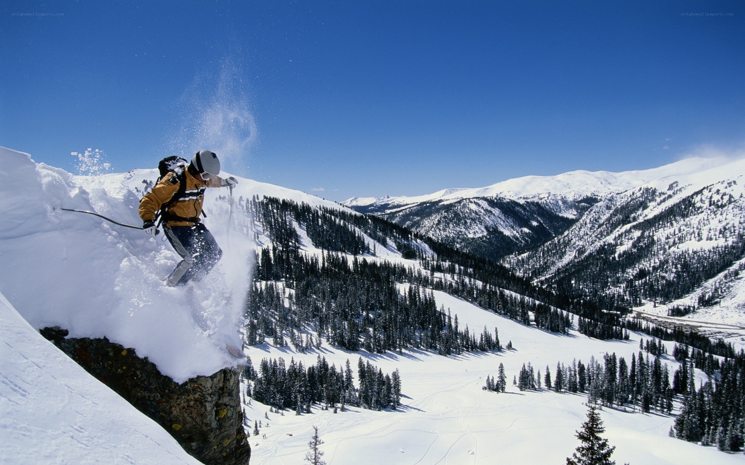 Skier jumping off a cliff
