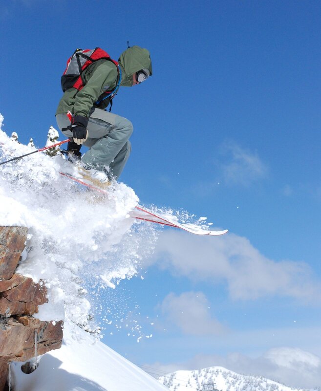 Skier jumping off a cliff
