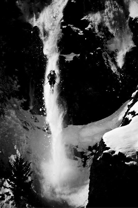 Skier jumping over waterfall
