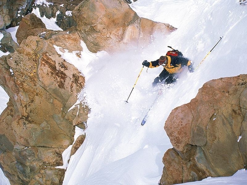 Skier navigating a snowy canyon