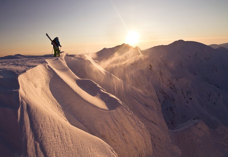 Skier on a snowy mountain peak