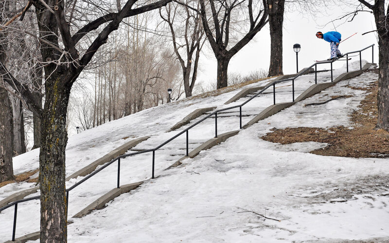 Skier on rail in snowy park
