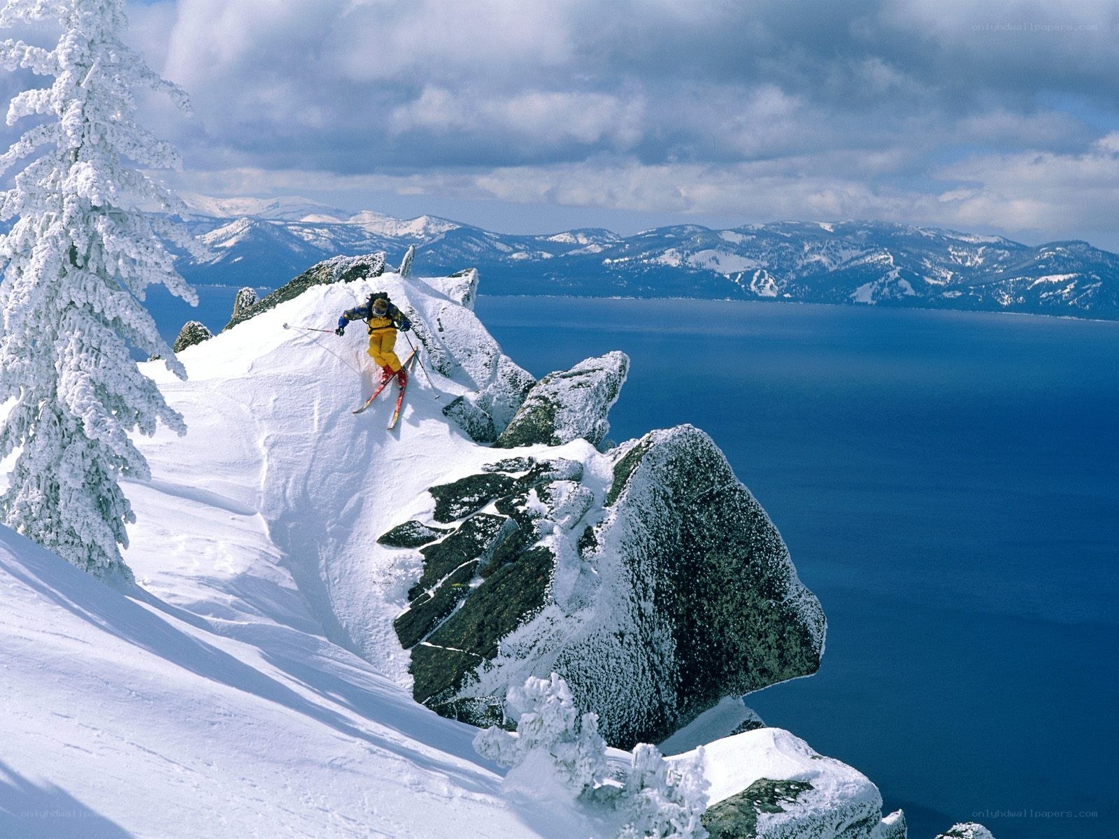 Skier on snowy cliff edge