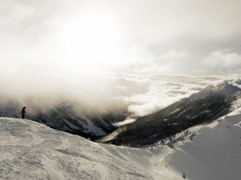 Skier on snowy mountain peak