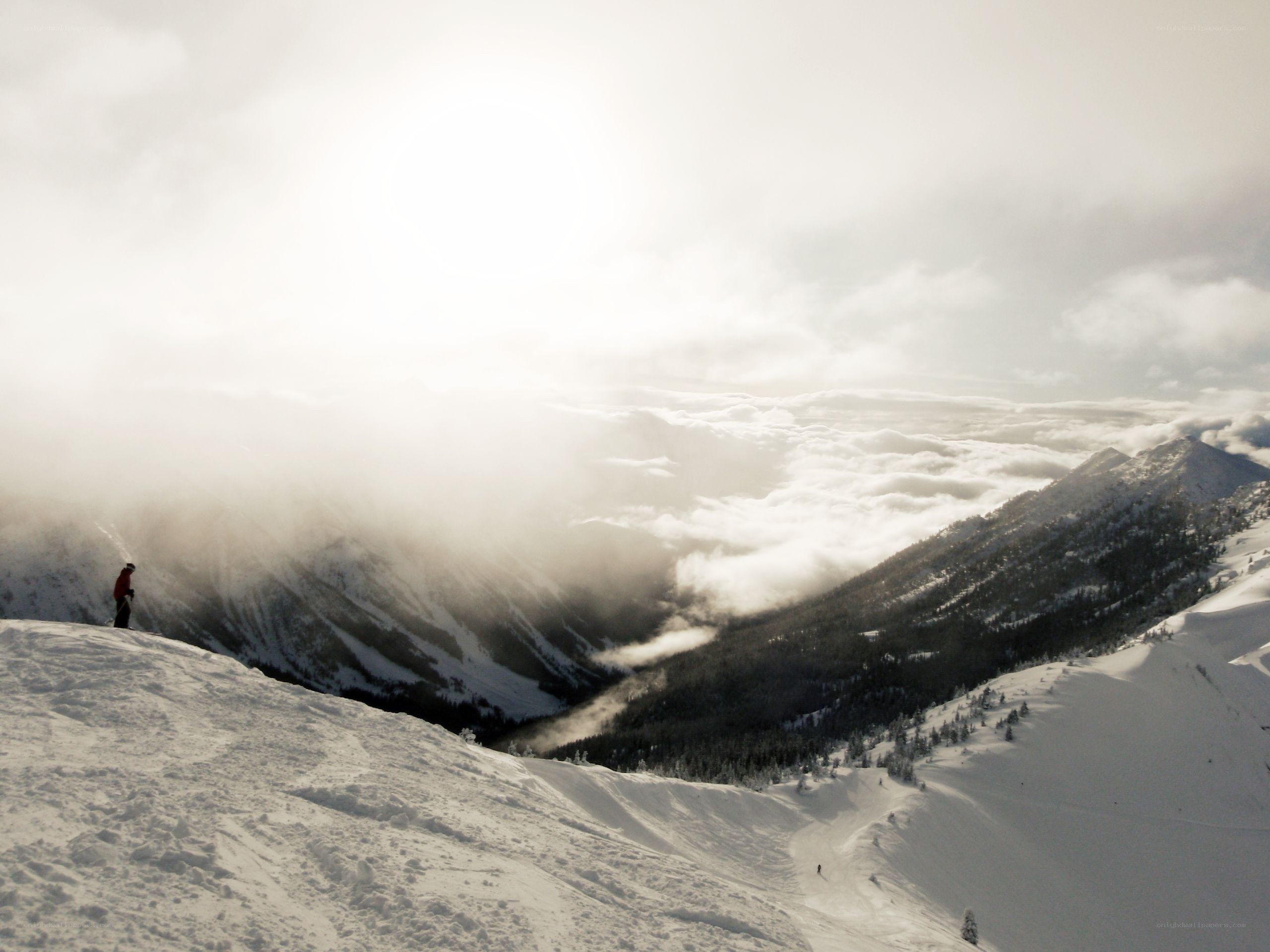 Skier on snowy mountain peak