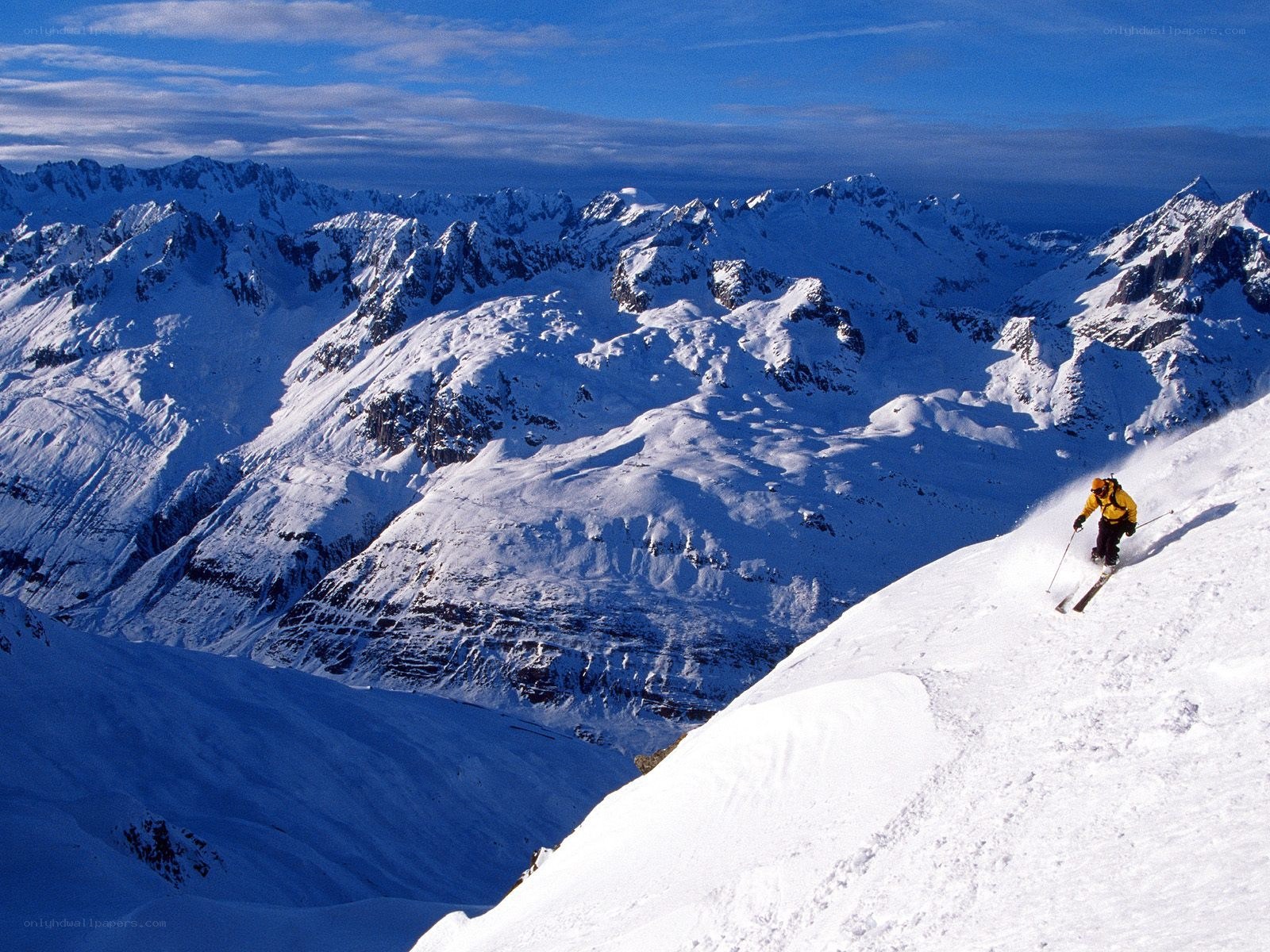Skier on snowy mountain slope