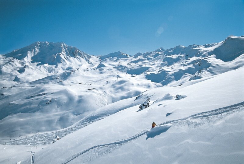 Skier on Snowy Slope — White, Serene