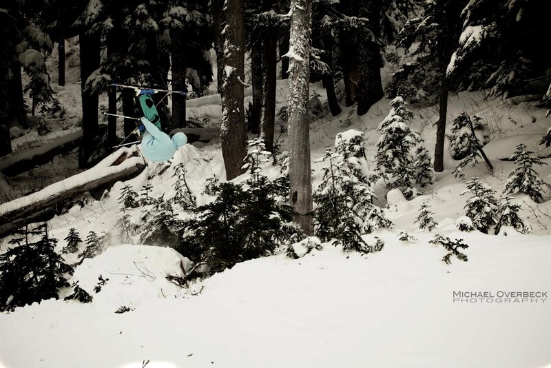 Skier performing a flip in the woods