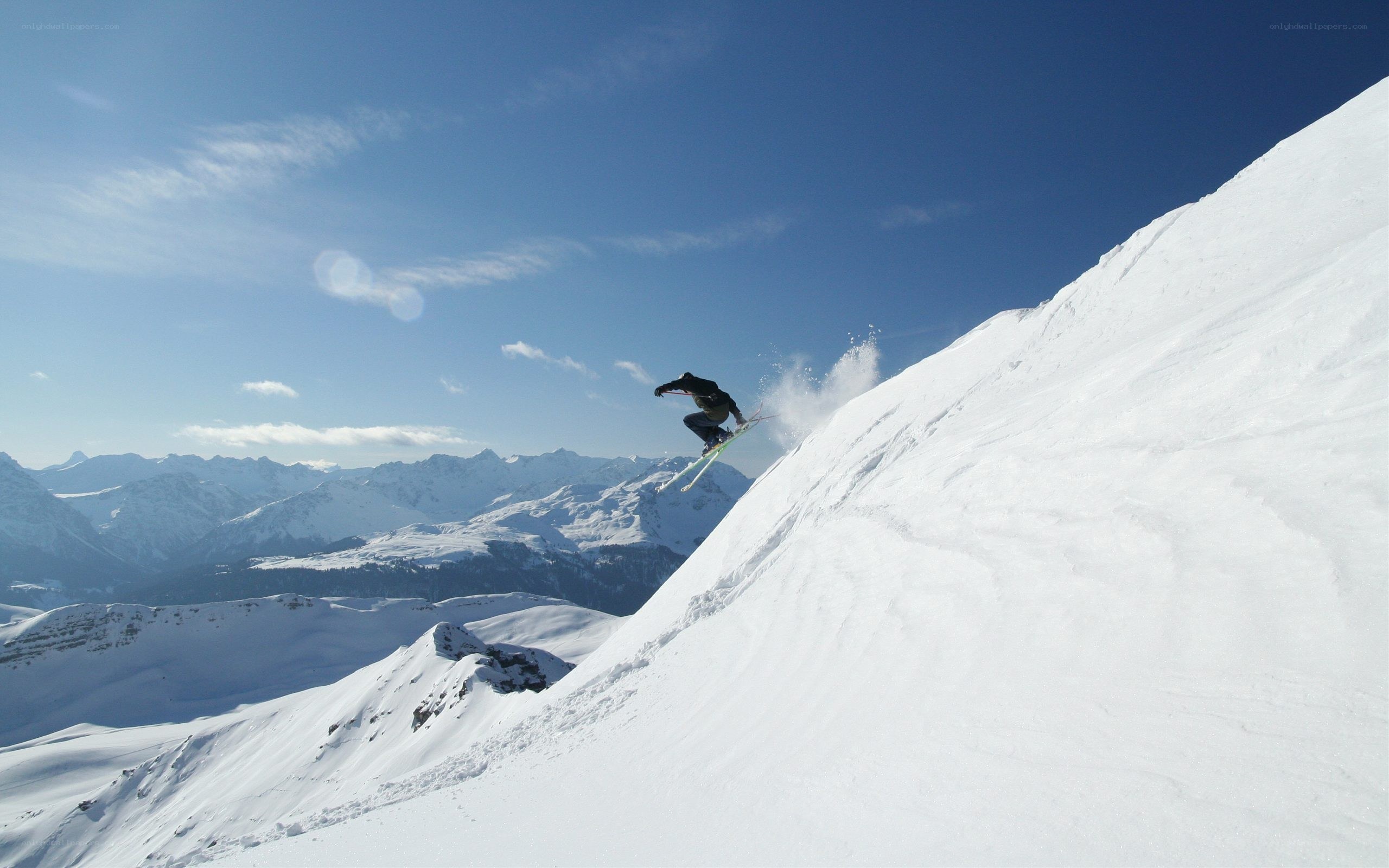 Skier performing jump in mountains
