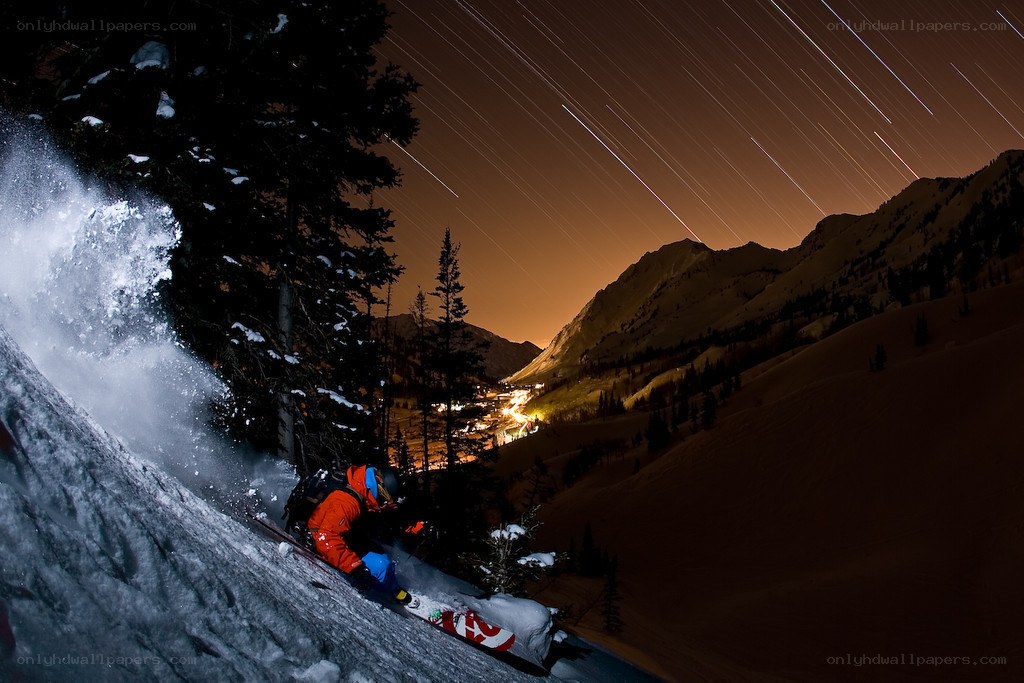 Skier under star trails at night