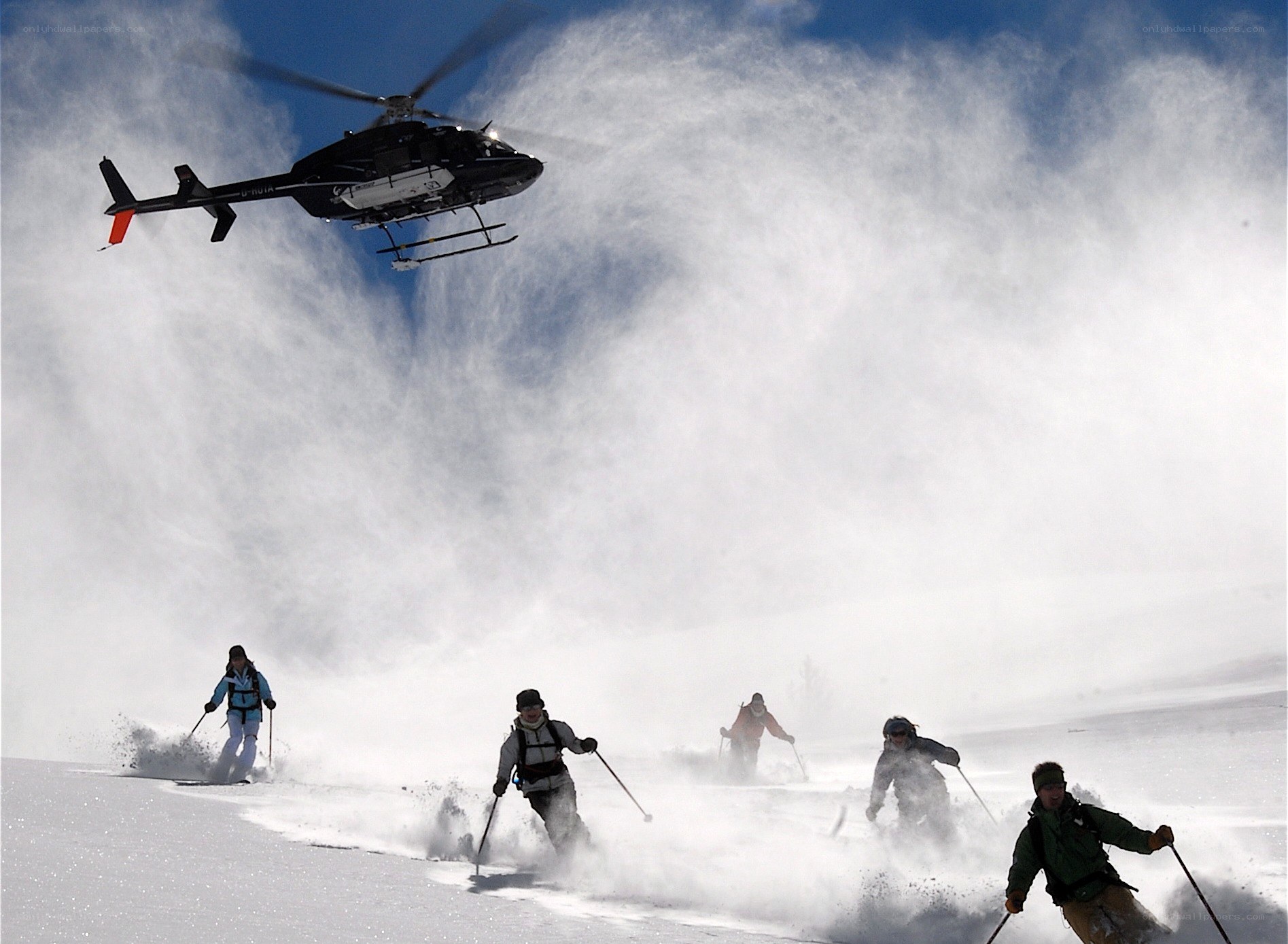 Skiers and helicopter in snow