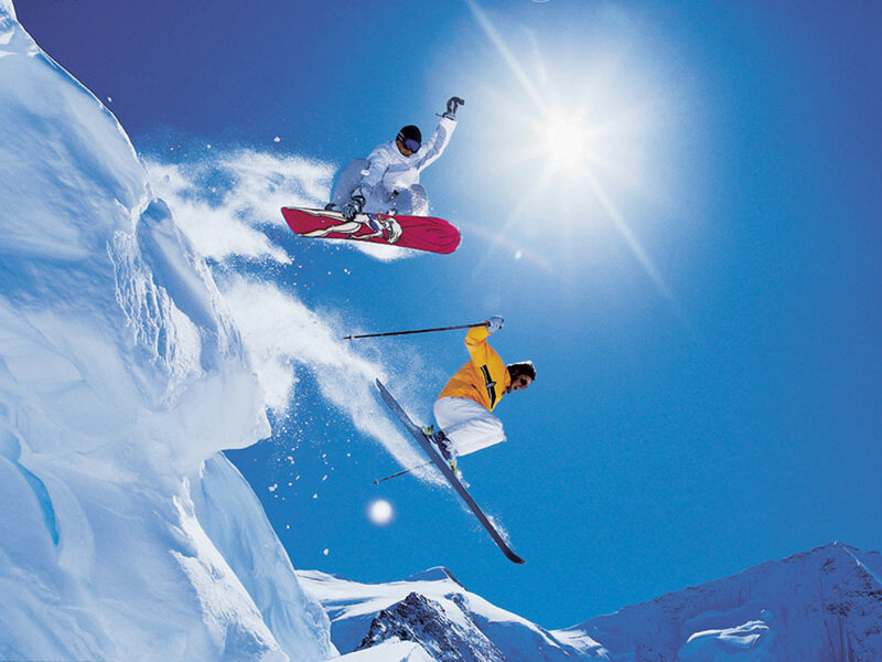 Skiers and snowboarders in action
