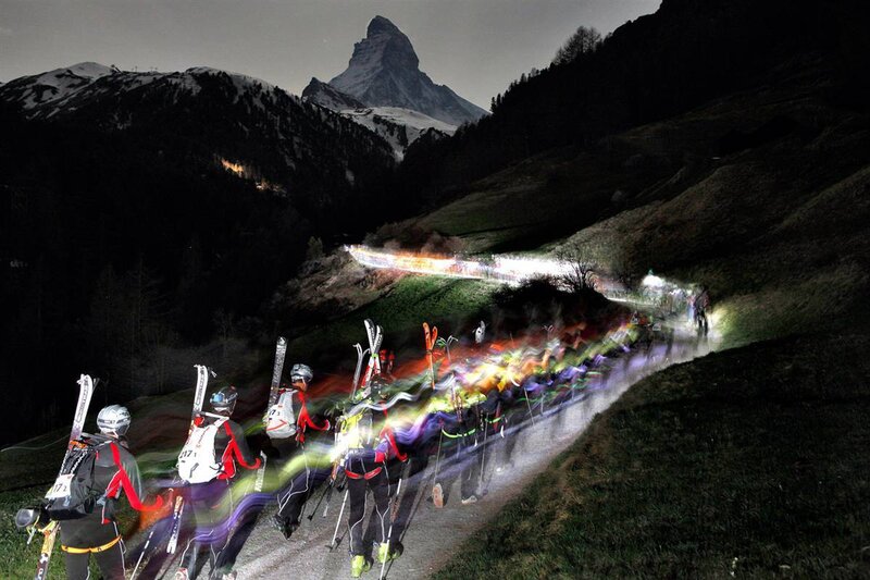 Skiers at night with Matterhorn