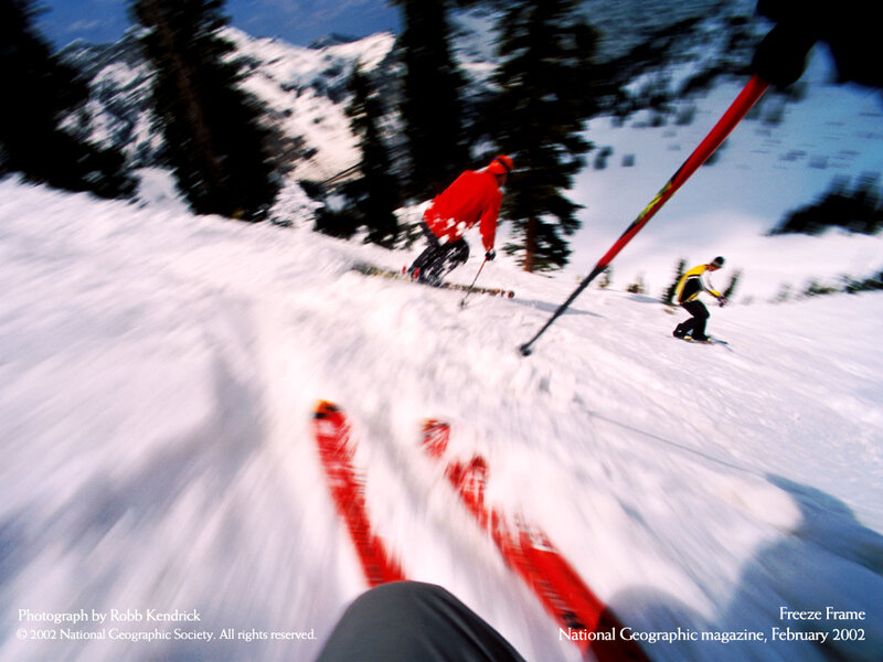 Skiers in motion on a snowy slope