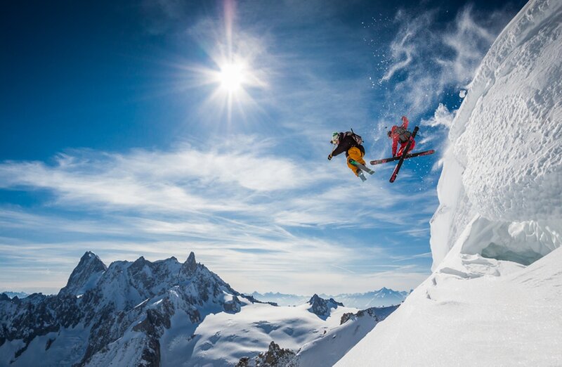 Skiers Jumping Off Cliff