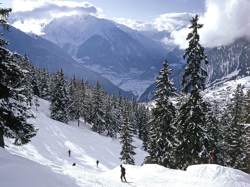 Skiers on a snowy mountain slope