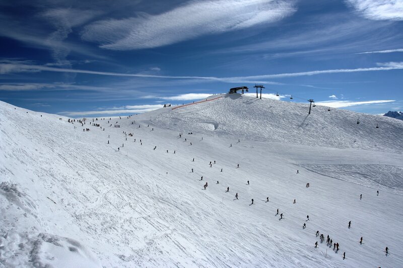 Skiers on a snowy mountain slope
