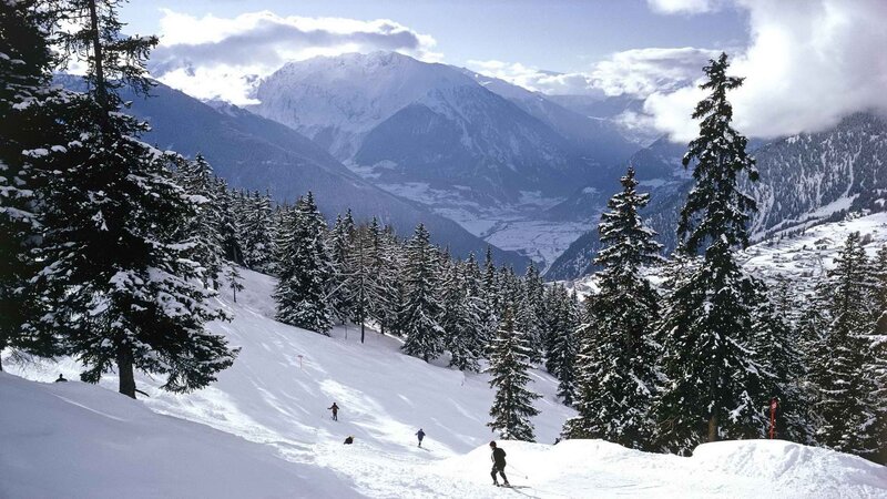 Skiers on a snowy mountain slope