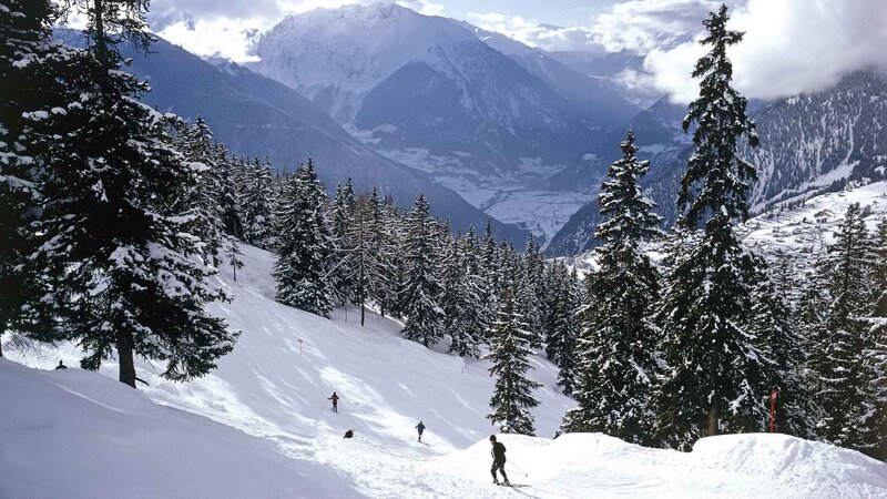 Skiers on a snowy mountain slope
