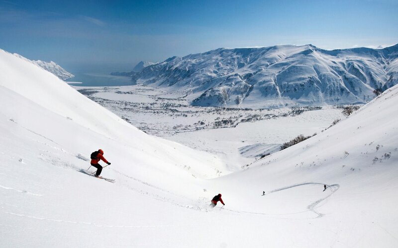 Skiers on a snowy mountain slope