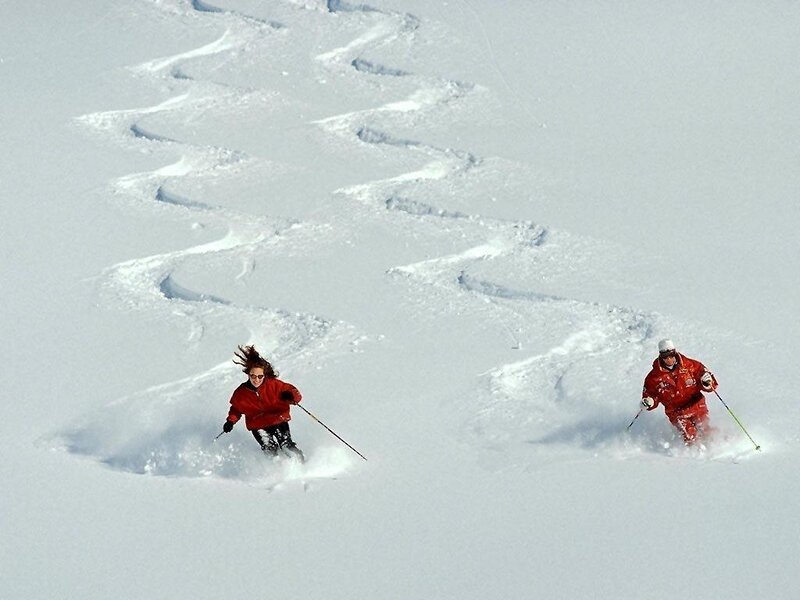 Skiers on a snowy slope