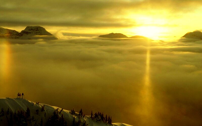 Skiers on Snowy Peak