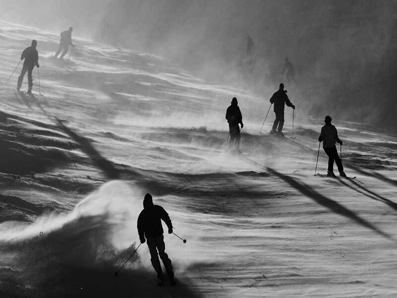 Skiers on Snowy Slope — Black, Dramatic