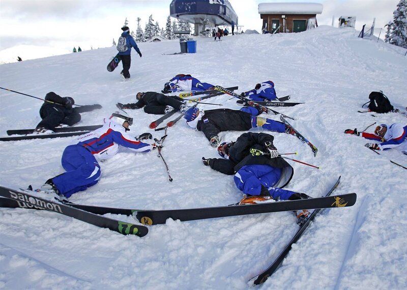 Skiers resting on a snowy slope