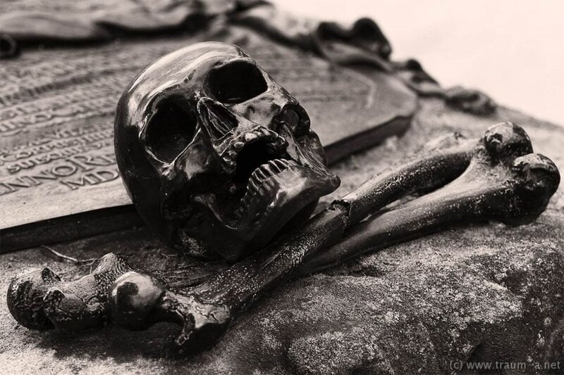 Skull and bones on gravestone