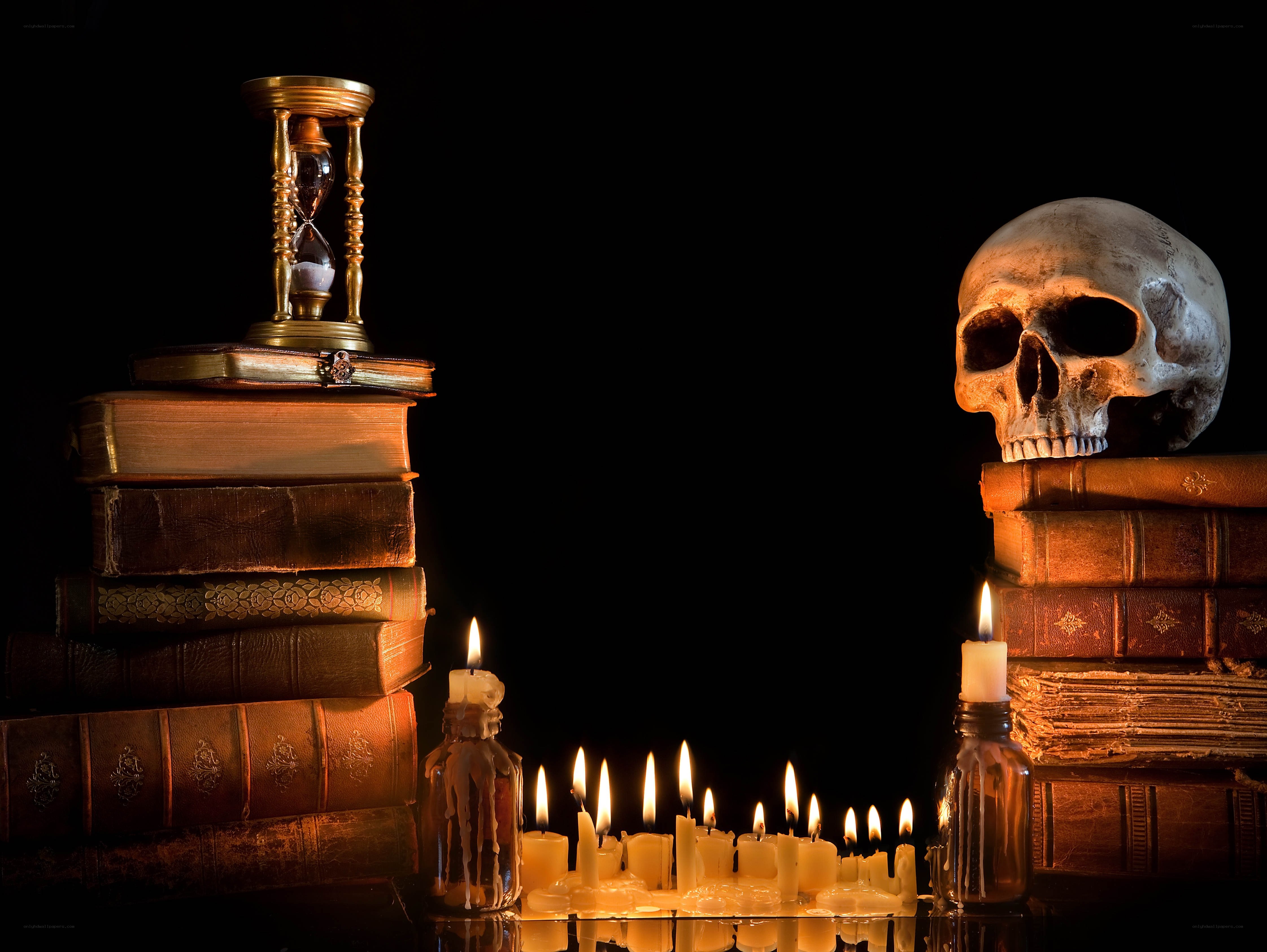skull and books with candles