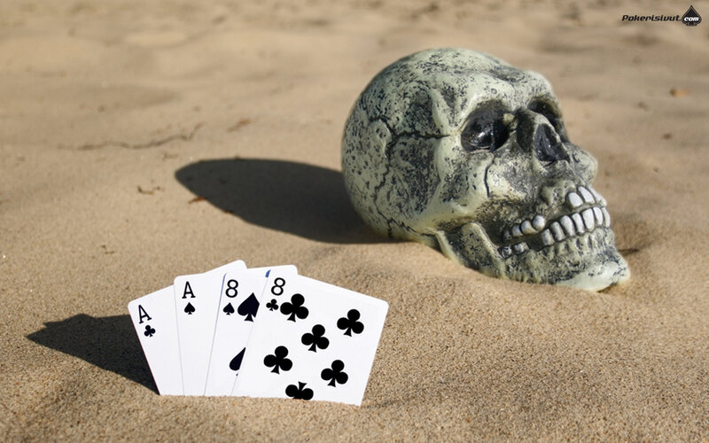 Skull and cards on the beach