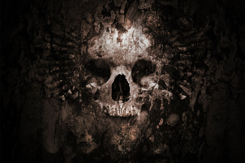 skull carved in cave wall