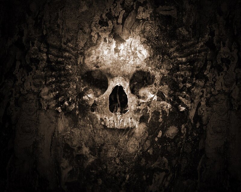 skull carved into stone wall