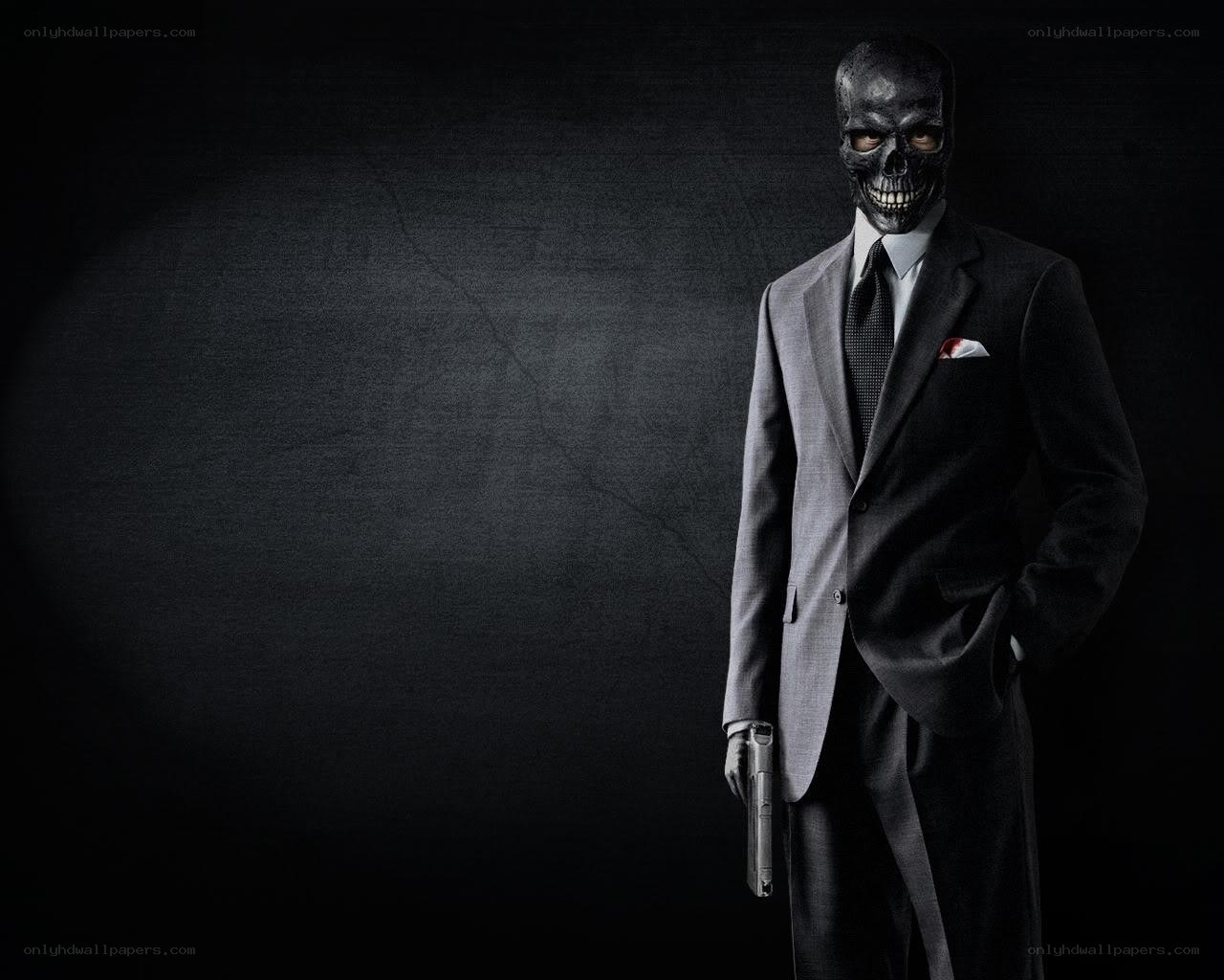 skull-faced man in suit