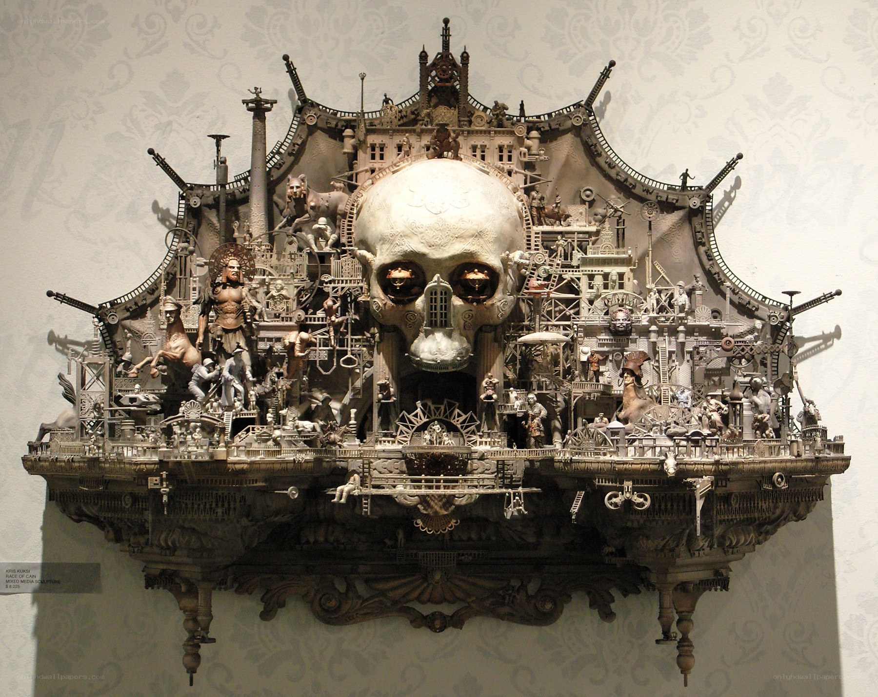 Skull sculpture with figures